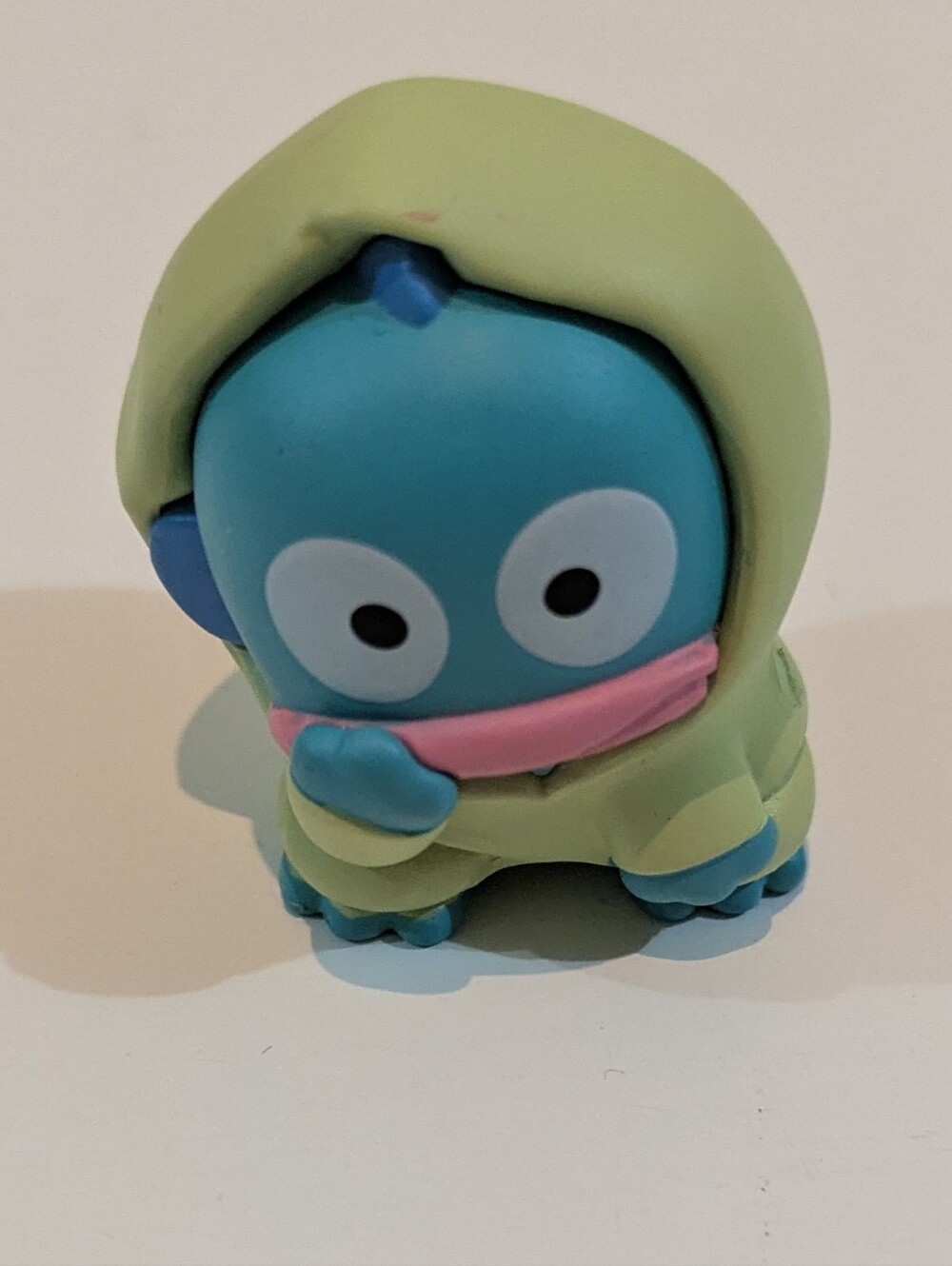 Sanrio Hangyodon Blue Character Figure with Green Hood and Pink Scarf